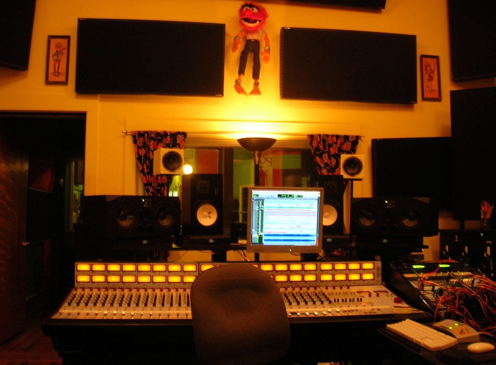 A mixing console in a recording studio, lit by a desk lamp